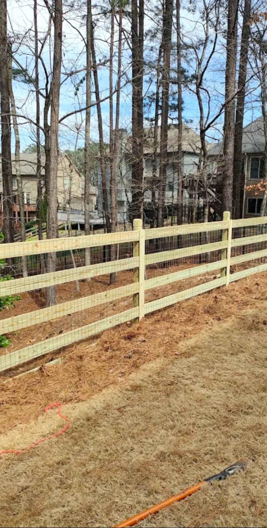 Wood fence installation with wire mesh